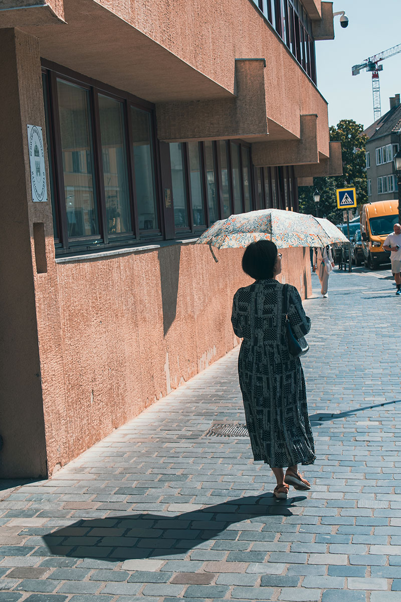 A lady—East Asian, if you ask me—strolling around Buda Castle in Budapest, Hungary: a rare kind of calm, and a lovely match for the warm summer sun