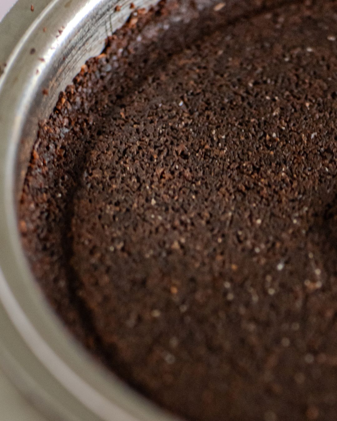 Ground coffee in the portafilter basket after the morning coffee-making process is complete