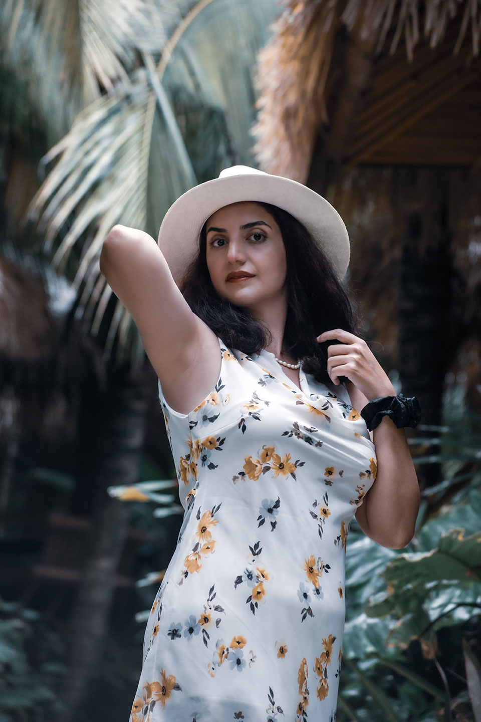 A beautiful Persian woman on Phi Phi Island in Thailand, among papaya trees.