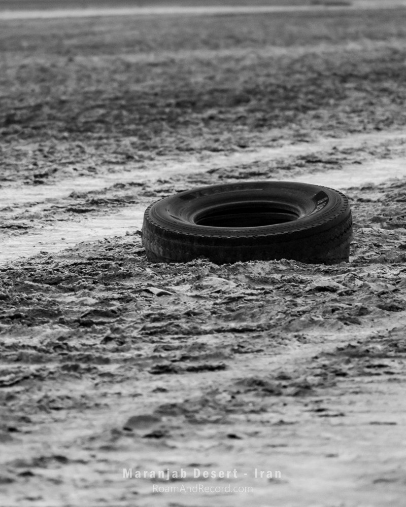 An abandoned tire lying in the middle of a salt lake near the Maranjab Desert in Iran