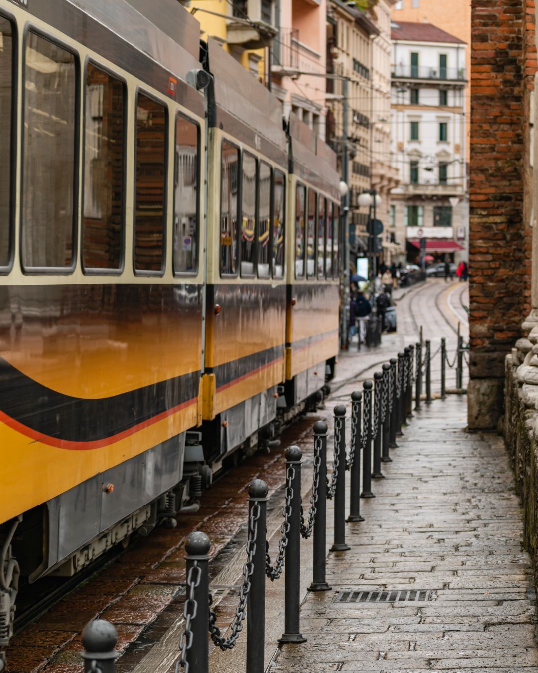 A tram making its way down one of Milan’s streets on a rainy spring day