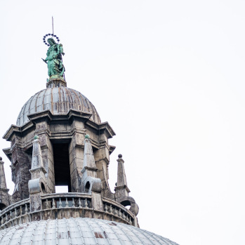A close-up view of the dome and the bronze statue on top of it at Basilica Santa Maria della Salute