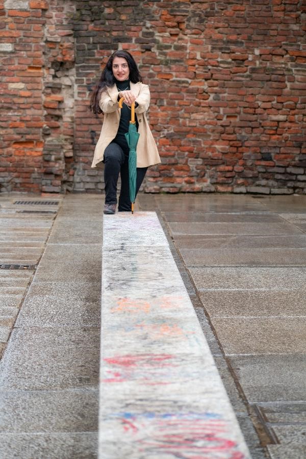 A woman in a modern and classic dress on a street in Milan