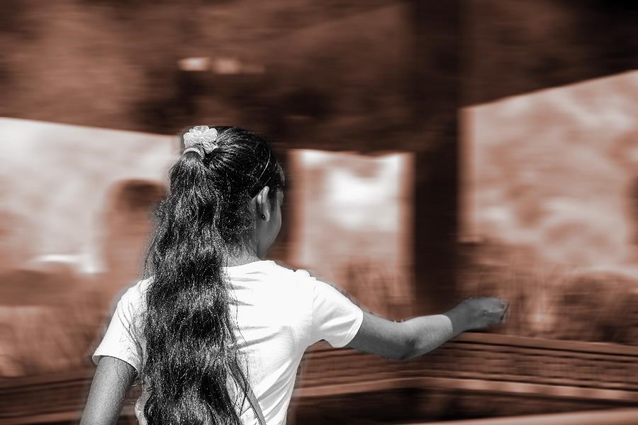 A girl lighting a candle in a temple in Kandy, Sri Lanka