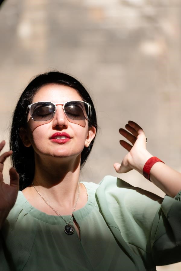 A beautiful woman standing in the bright shadow of Barcelona's Gothic alleys.