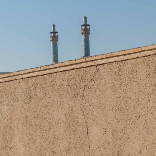 Mudbrick Wall with Mosque Minarets