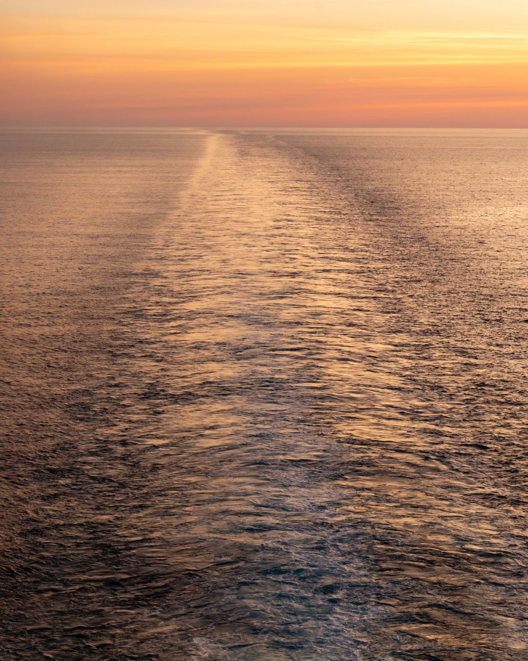 The wake stretching across the Mediterranean waters after a giant ship passed by