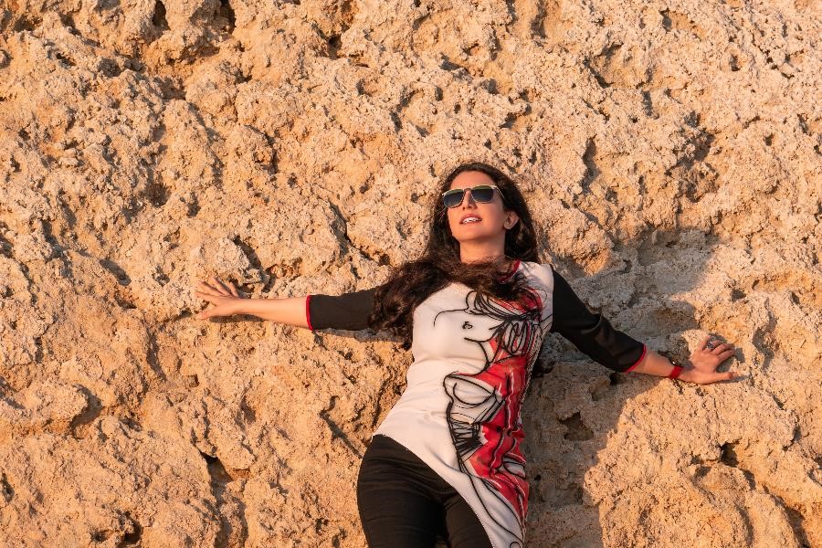 A Persian woman in front of a coral reef in Kish Island