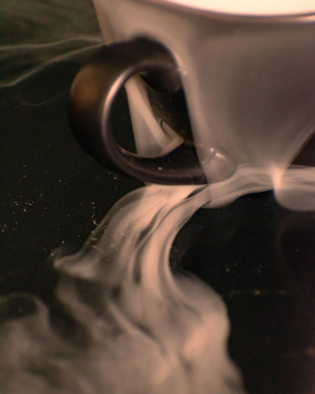 The result of a creative photo shoot of an empty coffee cup, with wisps of mist and steam drifting from inside the cup outward