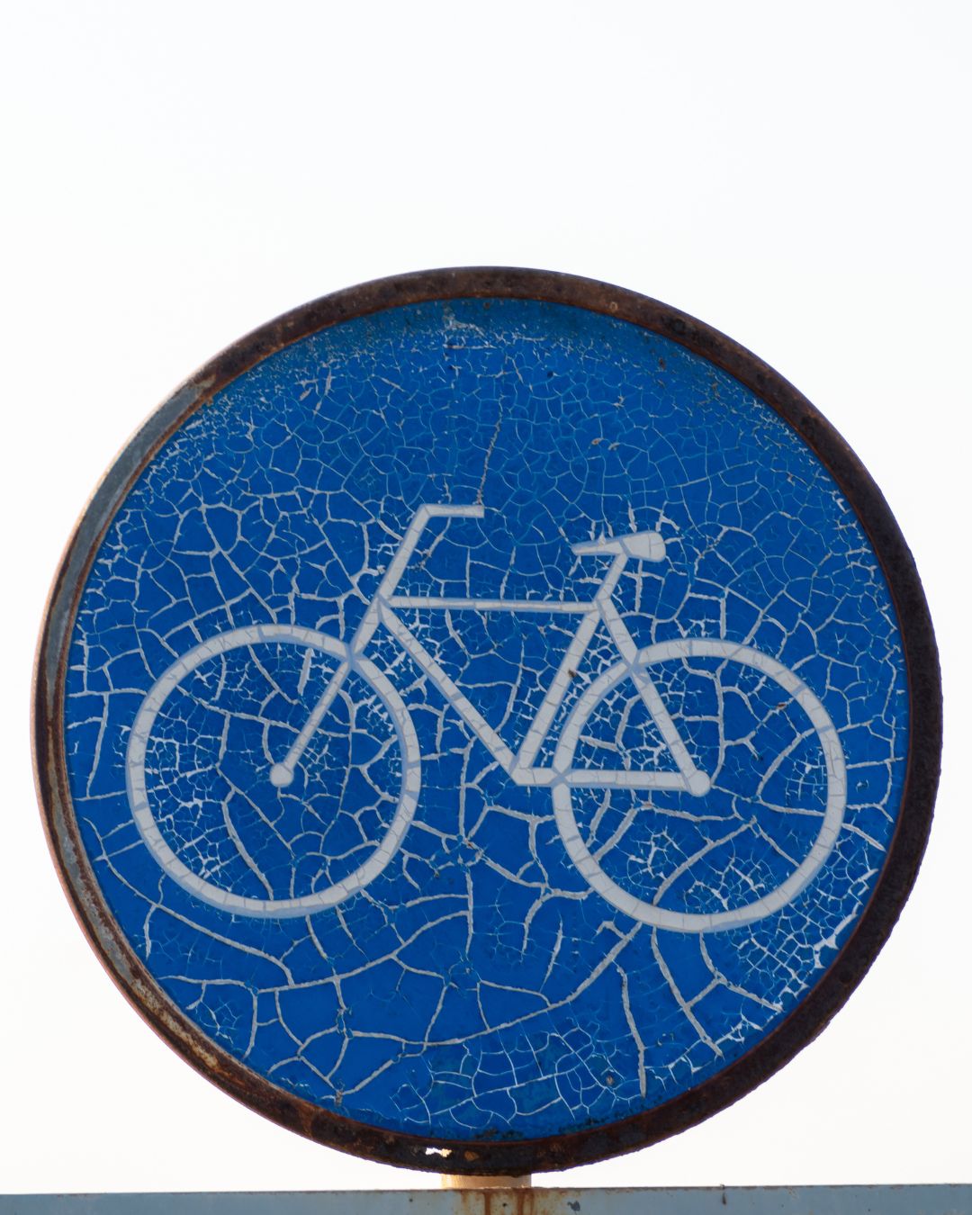 A bicycle-route sign on Kish Island — the scorching Persian Gulf sun has made the sign’s blue background peel and flake