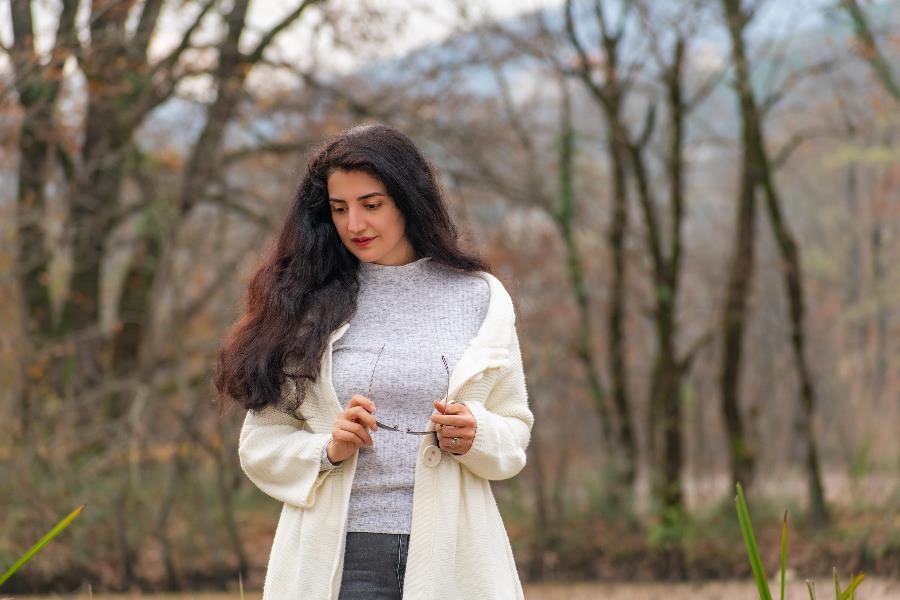 A minimal and simple image of a Persian woman in front of a lake in the city of Lahijan in Iran