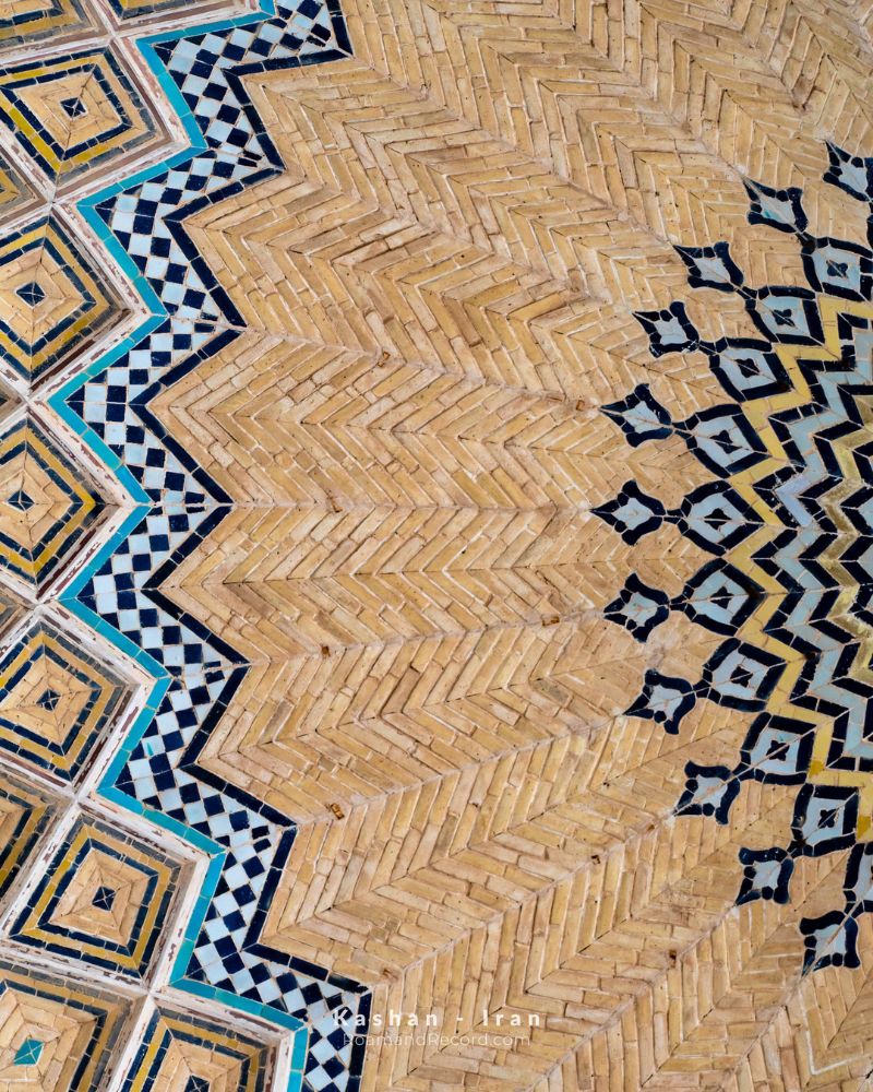A mix of brick and geometric tiles on the ceiling of the Agha Bozorg Mosque in Kashan, Iran